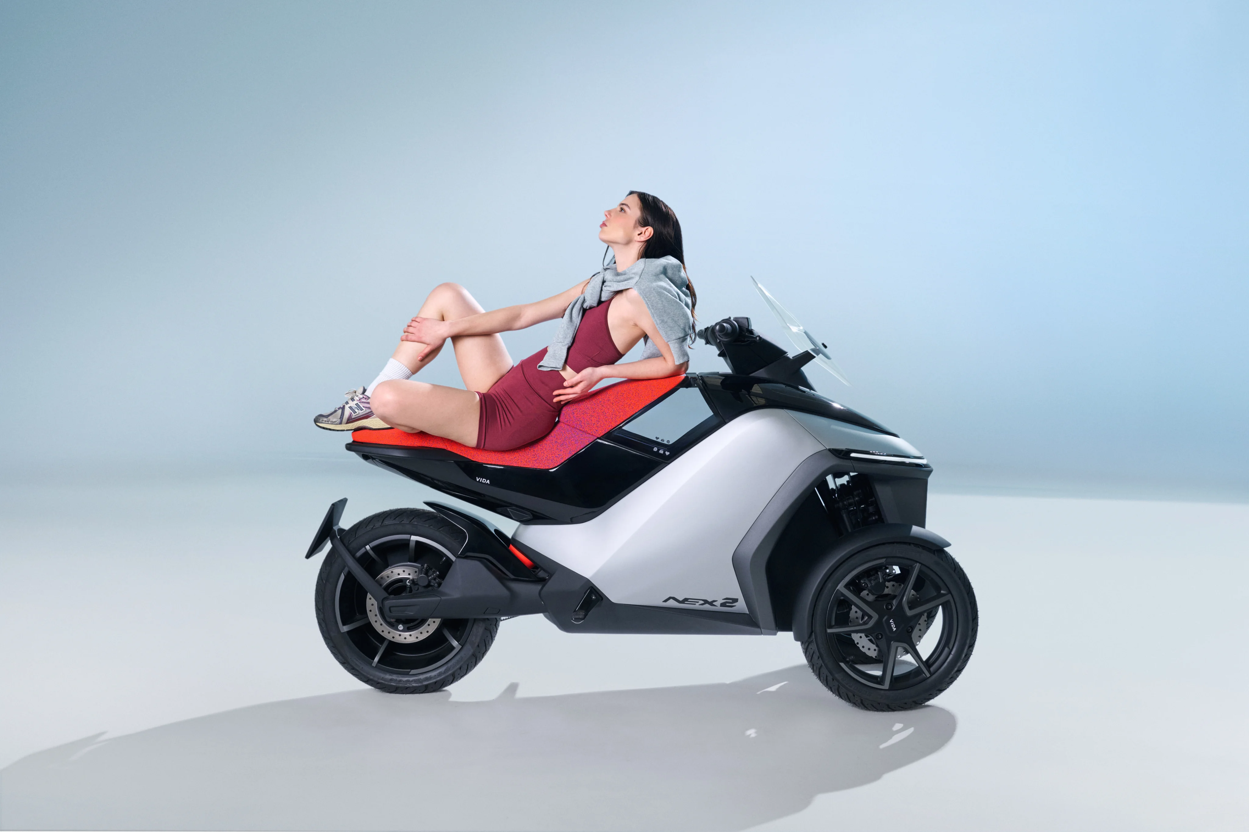 NEX2 concept card with three-wheeled urban mobility vehicle
